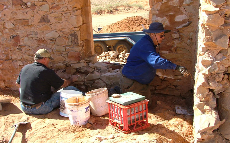 Volunteers re-pointing stonework