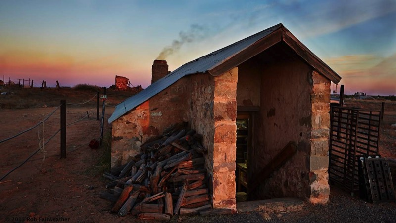 Bakery at dawn, oven stoked up and a pile of wood ready for the day ahead