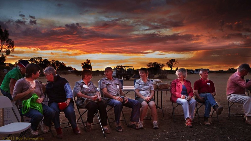 Sunset behind volunteers during the happy hour (and dinner)